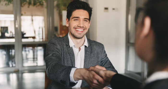 smiling-male-foreign-lawyer-shaking-hands-with-client