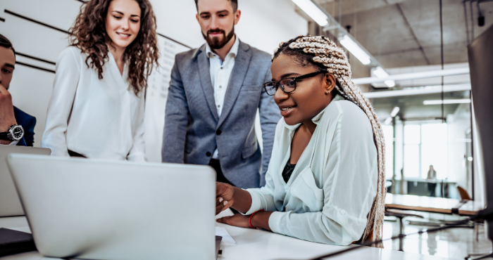 young-black-lawyer-showing-legal-team-a-report-on-a-laptop-during-a-team-discussion