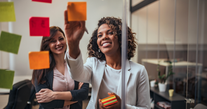 two-diverse-young-women-brainstorming-ideas-working-together