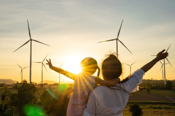 Wind turbines are alternative electricity sources, the concept o Wind turbines are alternative electricity sources, the concept of sustainable resources, People in the community with wind generators turbines, Renewable energy.