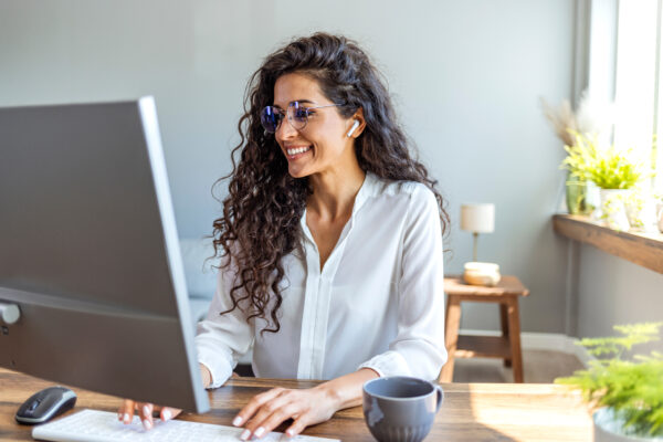 Shot of a young businesswoman working on a computer in an office Shot of a young businesswoman working on a computer in an office. Portrait of an successful young creative businesswoman using PC at her workplace in the modern office