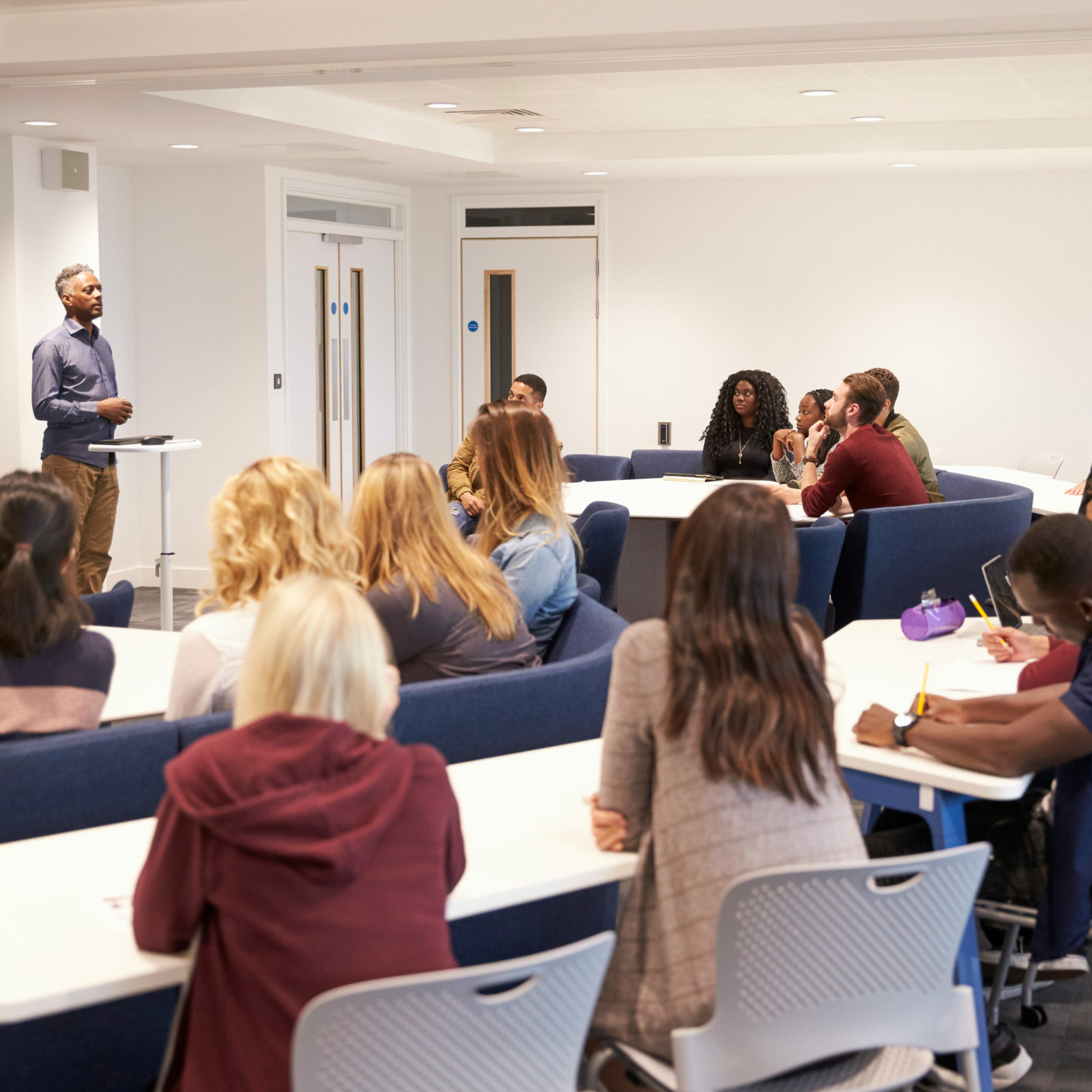 University students study in a classroom with male lecturer University students study in a classroom with male lecturer