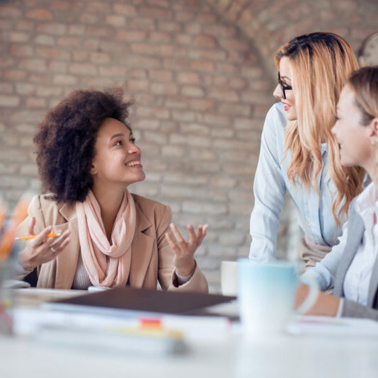 Group of young woman working together Young professional team.Young team of coworkers making great business discussion in modern office.