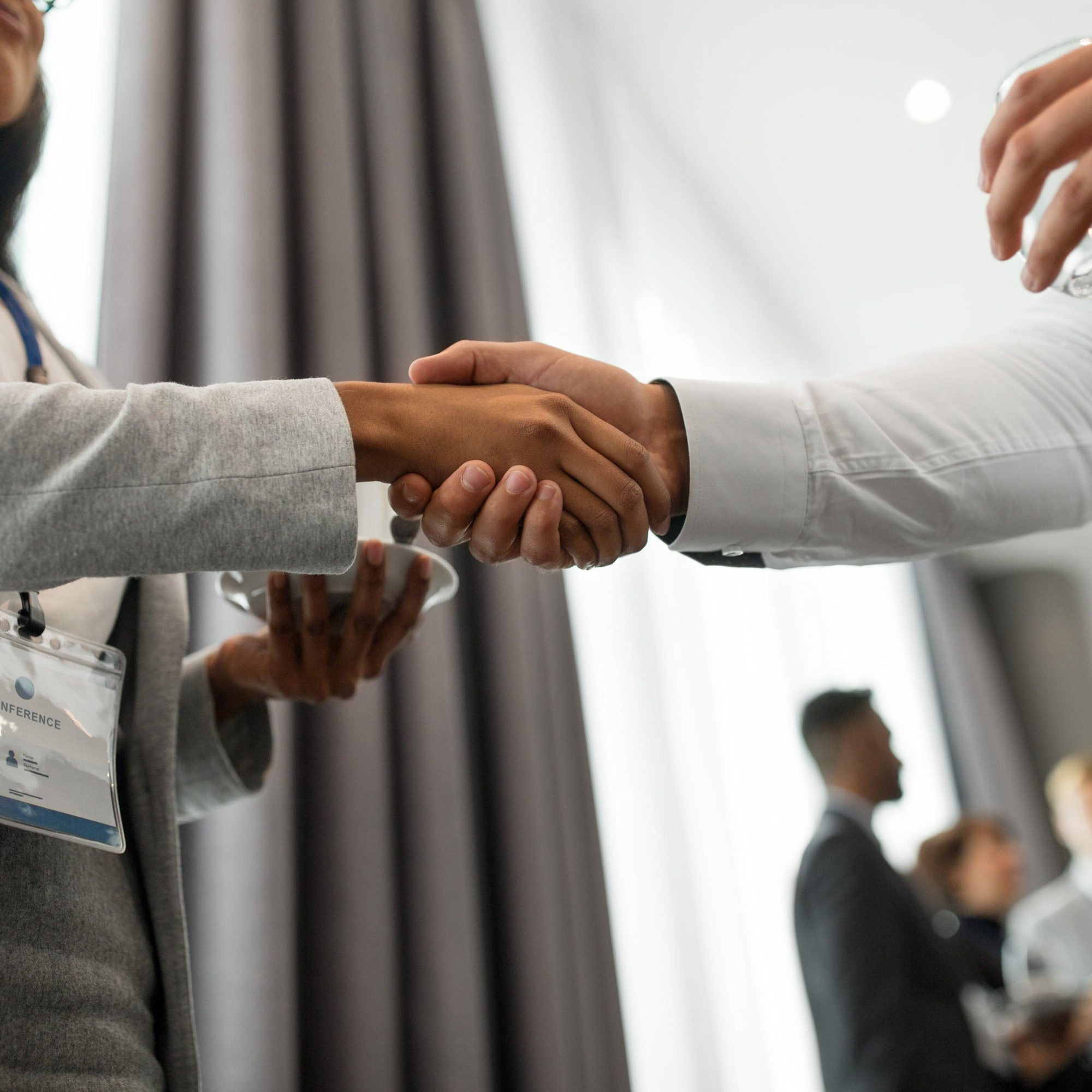 handshake of people at business conference gesture, partnership and cooperation concept - handshake of people at international business conference