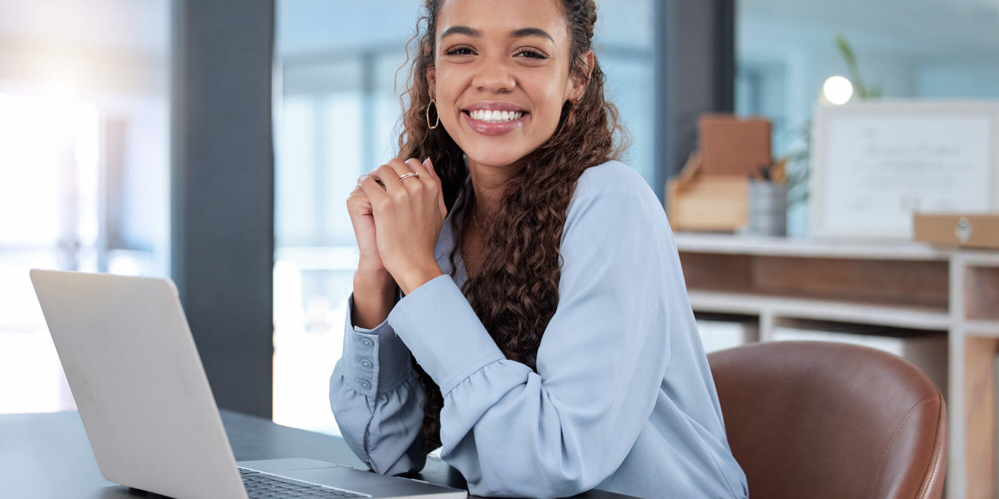 Cropped portrait of an attractive young businesswoman working on her laptop while sitting in the office.