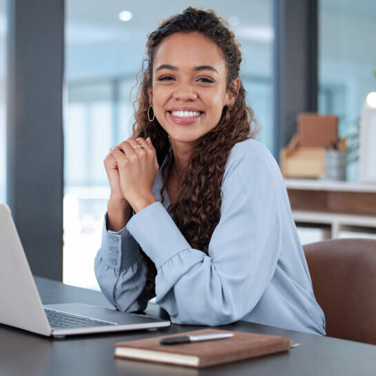 I love what I do. Cropped portrait of an attractive young businesswoman working on her laptop while sitting in the office. Cropped portrait of an attractive young businesswoman working on her laptop while sitting in the office.