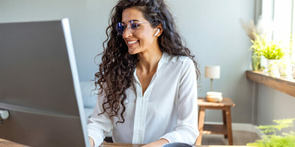 Shot of a young businesswoman working on a computer in an office. Portrait of an successful young creative businesswoman using PC at her workplace in the modern office